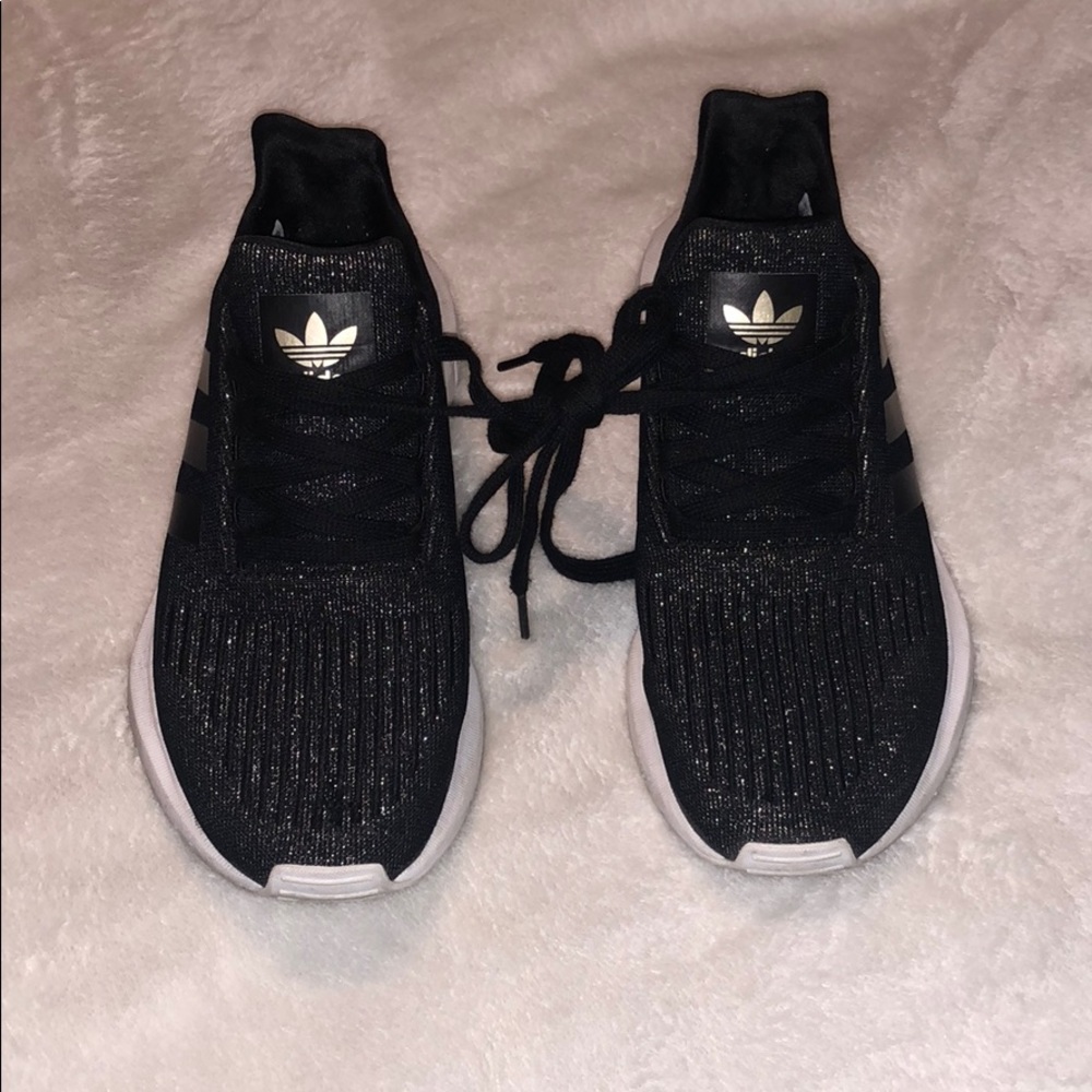 Black and gold Adidas sneakers